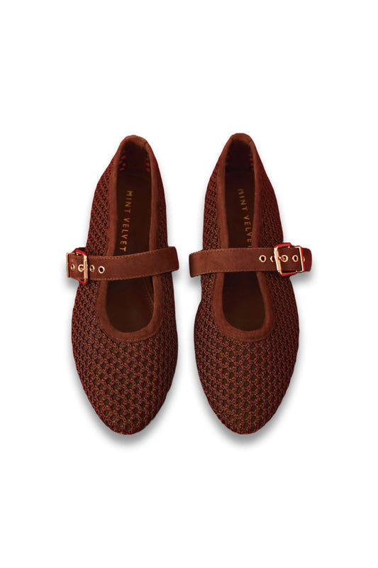 Pair of brown woven shoes with buckles on a white background